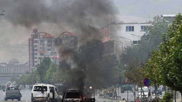 Smoke and flames rise from burning vehicles at the site of an attack in front of the Afghan parliament building in Kabul on June 22, 2015. (AFP/Shah Marai)