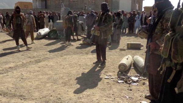 Afghan Taliban militants gather around parts of a US F-16 aircraft that was struck over in eastern Afghanistan. (AFP/File)