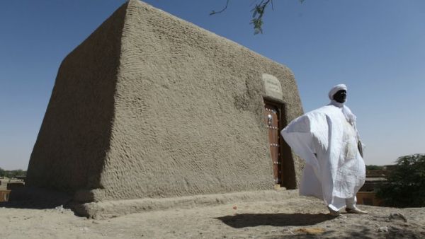 Sane Chirfi, representing the family that looks after the Alpha Moya mausoleum, poses in front of the recovered monument on February 4, 2016. (AFP/Sébastien Rieussec)