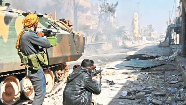 Turkey-backed Syrian opposition fighters take position during their advance in the city of Al-Bab, 30 km from the Syrian city of Aleppo. (AFP/File)