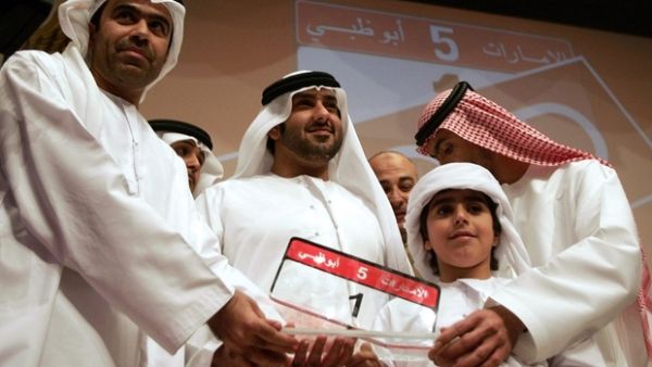 Emirati Saed Abdul Ghaffar al-Khouri poses with the most expensive car number-plate after he won it in an Abu Dhabi auction in 2008 (AFP/File Photo)	