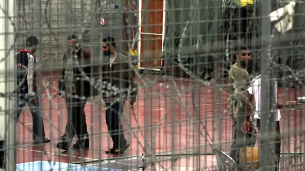 Palestinian prisoners walk at the yard of Megiddo Prison. (AFP/Menahem Kahana) 