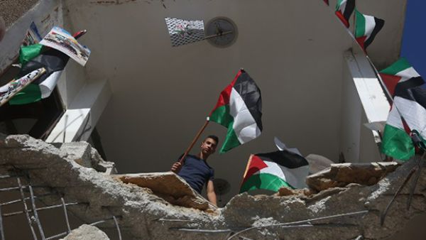 Palestinian flag are seen placed on the rubble of a house belonging to a Palestinian man who carried out a knife attack in Tel Aviv. (AFP/File)