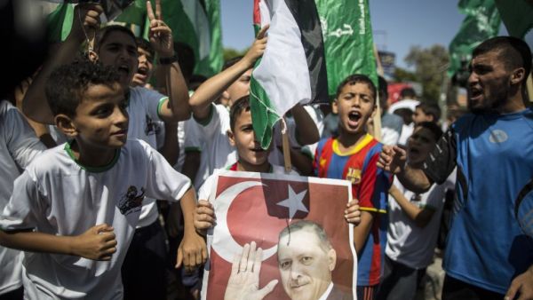 Palestinian supporters of the Hamas movement hold portraits of Turkish President Recep Tayyip Erdogan as they shout slogans against the military coup. (AFP/File)  Palestinian supporters of the Hamas movement hold portraits of Turkish President Recep Tayyip Erdogan as they shout slogans against the military coup. (AFP/File)