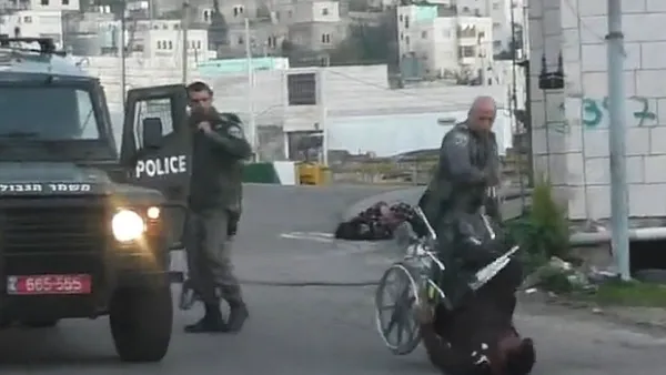 Palestinian man is knocked out of his wheelchair (Facebook / Raed Abu Rumaila)