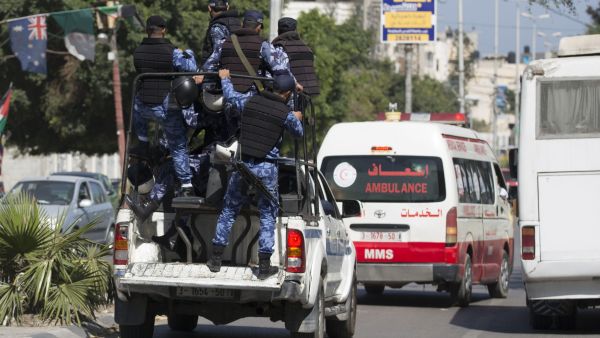 Hamas police escort an ambulance that was reported to be carrying the bodies of three men executed for "collaboration" with Israel, Gaza City, 6 April 2017. (AFP/Mohammed Abed)