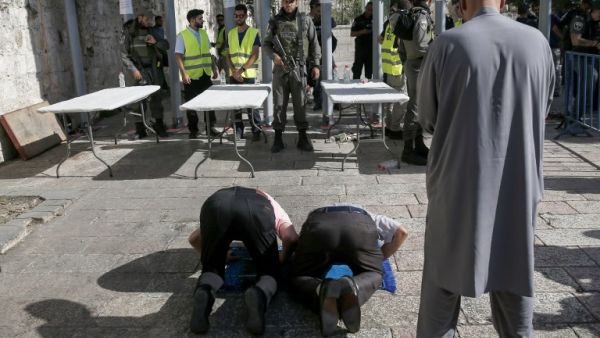Palestinians worship outside al-Aqsa compound in protest against security measures (Ahmad Gharabli/AFP)