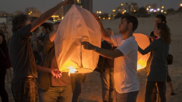 Israeli peace activists gather near the border fence with the Gaza Strip to launch into the air 150 sky paper lanterns in solidarity with Gaza residents on June 19, 2017, in the southern Israeli city of Ashkelon. (Jack Guez/AFP)