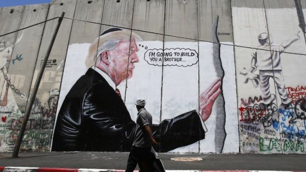'I'm going to build you a brother' reads new West Bank separation wall graffito (AFP)