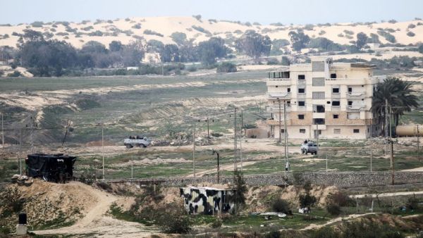 This photo taken on February 9, 2017 shows a picture taken from the southern Gaza Strip of Egyptian soldiers patrolling the Egyptian side of the Rafah border crossing. (AFP/Said Khatib)