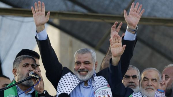 This file photo taken on August 27, 2014 shows Hamas leader in the Gaza Strip Ismail Haniya (C) waving to the crowd during a rally in Gaza City following a deal hailed by Israel and the Islamist movement as 'victory' in the 50-day war. (AFP/Mohammed Abed)