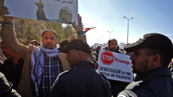 Palestinian protesters hold placards during a demonstration east of Jerusalem against US President-elect Donald Trump. (AFP/File)