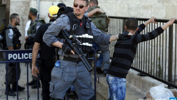 Israeli forces stop and search a Palestinian boy at the entrance of Damascus Gate, outside Jerusalem's Old City. ( AFP / Ahmad Gharabli)