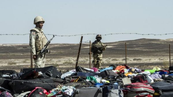 Egyptian army soldiers guard luggage and belongings of passengers of the A321 Russian airliner, at the site of the crash in Wadi al-Zolomat. (AFP/Khaled Desouki)