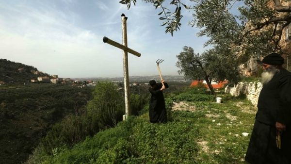 Greek Orthodox monks work in a garden at the monastery of Our Lady of Hamatoura in northern Lebanon on March 08, 2016. (AFP/ File Photo)