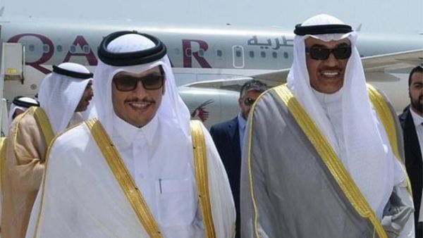 A handout picture released by the Emiri Diwan in Kuwait on July 3, 2017, shows Kuwaiti Foreign Minister Sheikh Sabah al-Khaled al-Sabah (R) receiving Qatari Foreign Minister Sheikh Mohammad Bin Abdulrahman al-Thani at Kuwait International Airport. (AFP)
