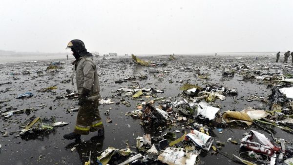 Russian emergency rescuer walks through wreckage of the flydubai passenger jet which crashed, killing all 62 people on board as it tried to land in bad weather in the city of Rostov-on-Don on March 19, 2016. (AFP)