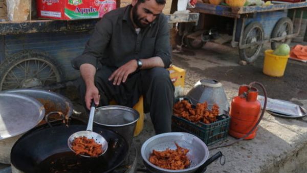 An Afghan vendor prepares traditional food in a street during the month of Ramadan in Ghazni on July 18, 2013.  ( RAHMATULLAH ALIZADA/AFP/Getty Images)