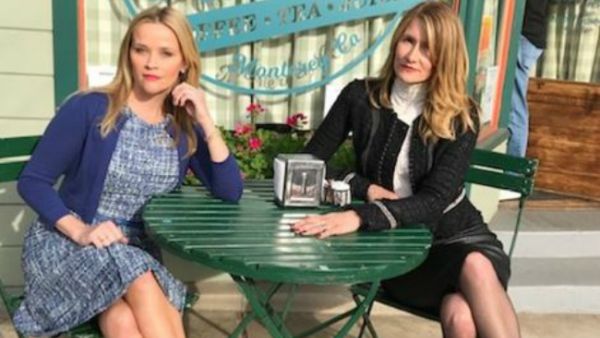 The picture shows Witherspoon and Dern sitting outside Seaside Coffee Shop in Monterey, Calif. Witherspoon wears a blue dress with a cardigan, while Dern sports a white turtleneck with a black skirt and cropped jacket. (Source: lauradern - Instagram)
