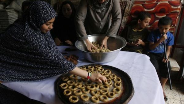 Palestinians celebrate the Eid by making sweet pastries.
