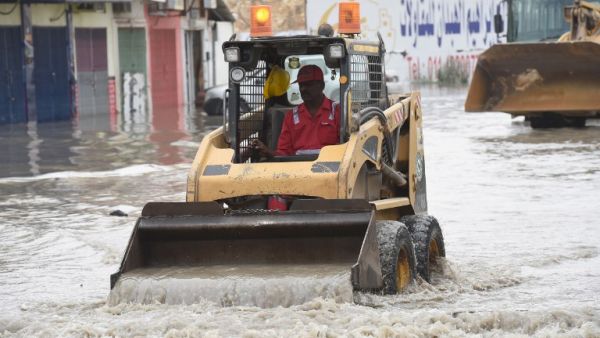 A Saudi worker clears a flooded street in Riyadh. (AFP/Fayez Nureldine)