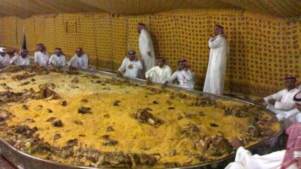 Saudi men and a very large plate of Kabsa. [hotterthanapileofcurry]