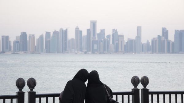 Two girls look out at the Doha skyline. Qatar's hydrocarbon growth is not what it used to be. But its non-oil growth has shot to over 10 percent (Albawaba/J. Zach Hollo)