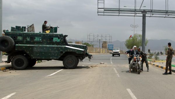 Yemeni soldiers search a motorbike at a checkpoint on a street leading to the US embassy compound in Sanaa (AFP/ MOHAMMED HUWAIS)