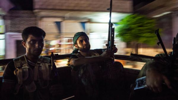 Syrian rebels head to the town of Bsankol in the northwestern province of Idlib to join comrades fighting regime forces for the control of the highway that connects Idlib with Latakia on July 11, 2013. (Source: AFP/DANIEL LEAL-OLIVAS)