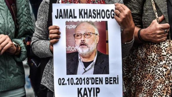 A woman holds a portrait of missing journalist and Riyadh critic Jamal Khashoggi. (AFP/File)