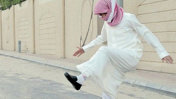 A Saudi student stomps on shredded books after exams. (File photo)