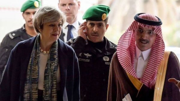 British Prime Minister Theresa May (L) is escorted by Saudi Finance Minister Mohammed al-Jadaan, upon their arrival to Saudi Stock Exchange (Tadawul) in the capital Riyadh on April 4, 2017. (AFP)