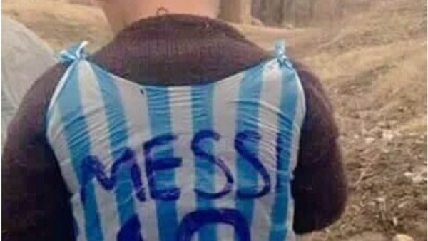 Little is certain about the tiny fan in the plastic jersey, but blogs and social media say he's from war-torn Iraq. (Twitter) 