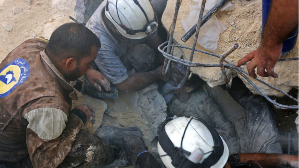 A child is rescued from the remains of an air strike in Aleppo  (AFP/Thaer Mohammed)