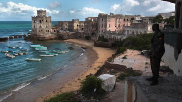 An African Union soldier from Uganda looks out over Mogadishu's harbor. [AFP]