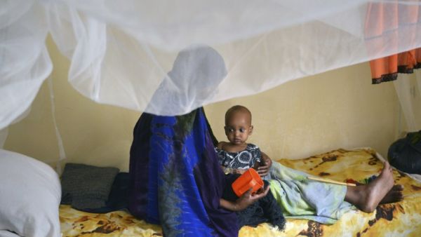 A malnourished child is fed a special formula by her mother at a hospital in Baidoa town in southwestern Somalia that has been hit by severe cases of malnourishment and cholera on March 15, 2017. (AFP/Tony Karumba)