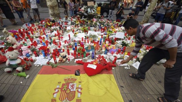A man displays a candle to pay tribute to the victims of the attack on Las Ramblas boulevard (AFP)