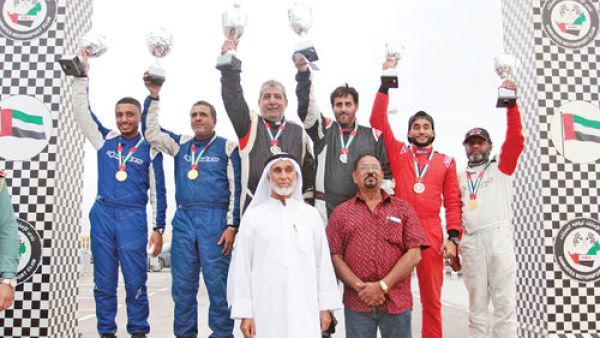Hamid al Qasimi (second from left) and Khalid al Soomar (right) with their trophies on the podium (Photo: Muscat Daily)