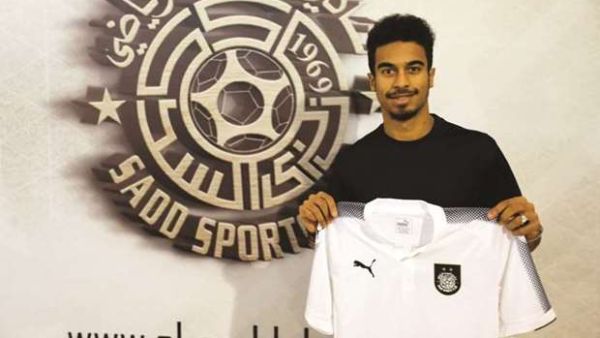 Akram Afif poses with Al Sadd jersey after signing for the QNB Stars League team.