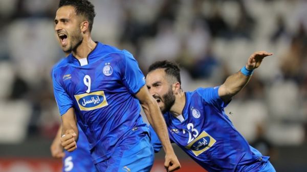 Esteghlal FC's Iranian forward Ali Ghorbani (L) celebrates with his teammates after scoring a goal against Al-Rayyan SC during their Asian Champions League football match at Jassim Bin Hamad Stadium in the Qatari capital Doha on February 13, 2018.
KARIM JAAFAR / AFP
