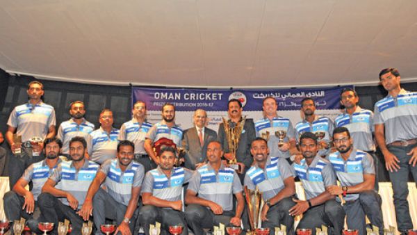 Assarain CT players and officials are all smiles as they display their trophies and awards after winning a domestic double in the 2016-17 season. Assarain won the Premier Division league and T20 titles (Photo: Muscat Daily)
