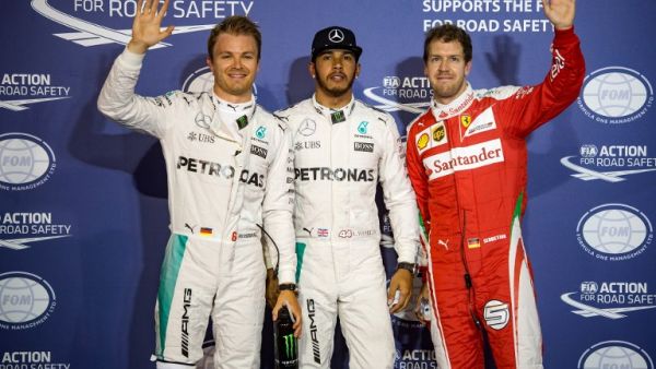 Mercedes AMG Petronas F1 Team's British driver Lewis Hamilton (C) stands next to Mercedes AMG Petronas F1 Team's German driver Nico Rosberg (L) and Ferrari's German driver Sebastian Vettel after securing the pole position in the Bahrain Formula One Grand Prix following the qualifying session at the Sakhir circuit in Manama on April 2, 2016, a day ahead of the race. AFP PHOTO / ANDREJ ISAKOVIC
ANDREJ ISAKOVIC / AFP