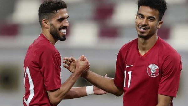Qatar's forward and captain Hasan al-Haydos (L) celebrates with his teammate Akram Afif after the second goal against Palestine national team during a friendly football match at the Khalifa International Stadium in Doha on September 11, 2018.
KARIM JAAFAR / AFP