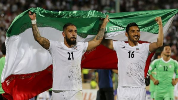 Iran's Ashkan Dejagah (L) Reza Ghoochannejad (R) celebrates among players after winning the 2018 World Cup qualifying football match between Iran and Uzbekistan at the Azadi Stadium in Tehran on June 12, 2017. Iran won 2-0.
ATTA KENARE / AFP