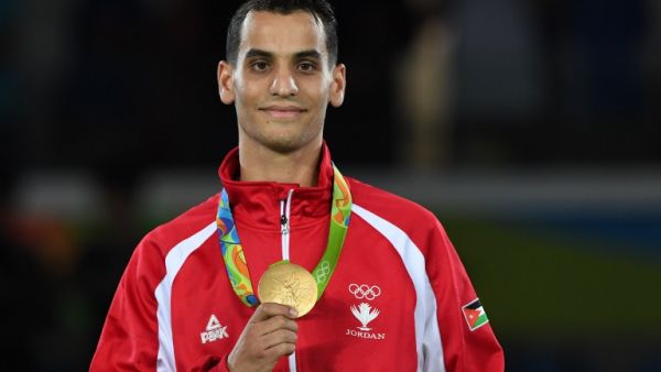 Jordan's Ahmad Abughaush poses with his gold medal on the podium after the men's taekwondo event in the -68kg category as part of the Rio 2016 Olympic Games, on August 18, 2016, at the Carioca Arena 3, in Rio de Janeiro.
Kirill KUDRYAVTSEV / AFP