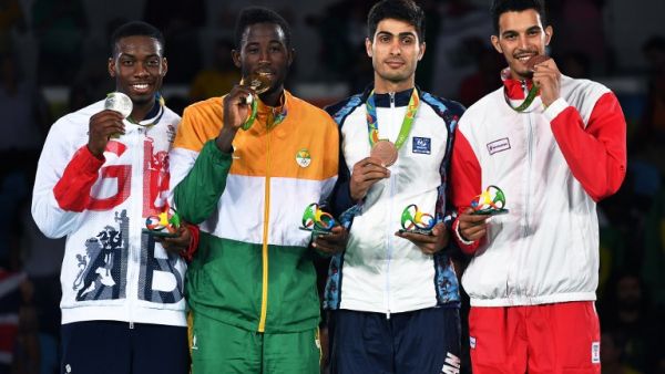 (L-R) Silver medalist Great Britain's Lutalo Muhammad, gold medalist Ivory Coast's Cheick Sallah Junior Cisse and bronze medalists Azerbaijan's Milad Beigi Harchegani and Tunisia's Oussama Oueslati pose with their medals on the podium after the men's taekwondo event in the -80kg category as part of the Rio 2016 Olympic Games, on August 19, 2016, at the Carioca Arena 3, in Rio de Janeiro.
Ed JONES / AFP