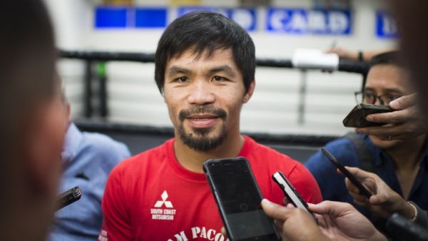 Filipino boxer Manny Pacquiao speaks with the media before his workout at the Wild Card Boxing Club in Hollywood, California, March 30, 2016. Pacquiao is in final preparation for his 12-round welterweight championship fight against Timothy Bradley, Jr. on April 9, 2016 in Las Vegas, Nevada. Veteran trainer Freddie Roach has vowed to back Pacquiao if the boxer decides to take advantage of rule changes which could see professional fighters allowed to take part in this summer's Olympics.
ROBYN BECK / AFP