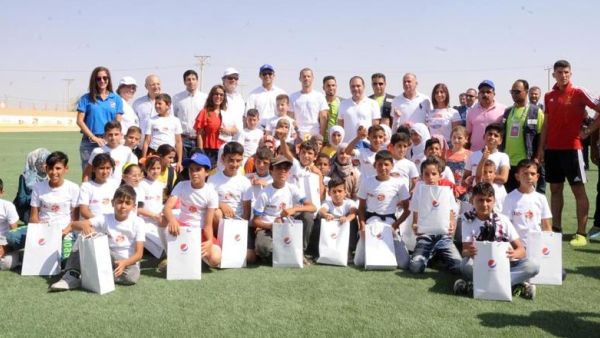 HRH Prince Ali poses for a group photo during the opening of a new artificial football pitch in the Zaatari Refugee Camp on Tuesday (Photo: PepsiCo)