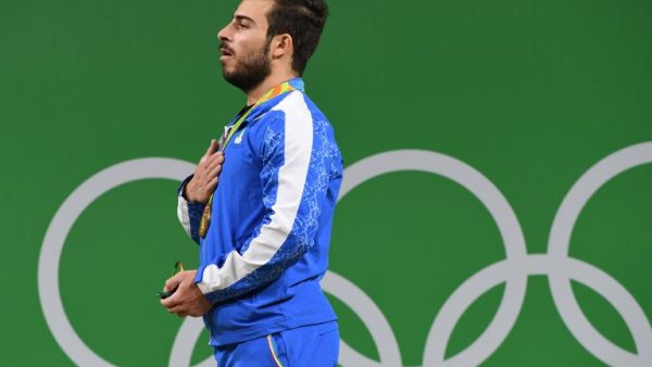 Iran's gold medallist Kianoush Rostami poses on the podium after the men's weightlifting 85kg event during the Rio 2016 Olympics Games in Rio de Janeiro on August 12, 2016.
GOH Chai Hin / AFP