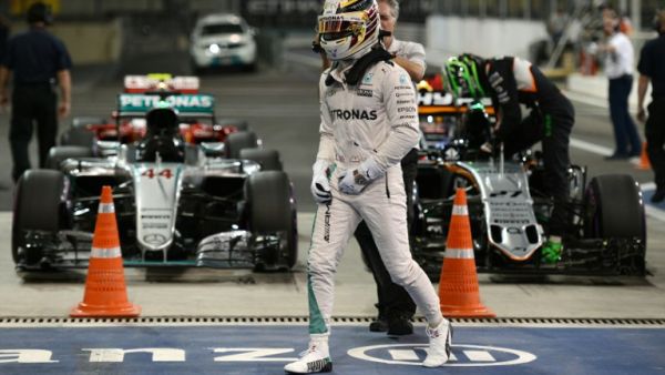 Mercedes AMG Petronas F1 Team's British driver Lewis Hamilton leaves his car after taking pole position in the qualifying session as part of the Abu Dhabi Formula One Grand Prix at the Yas Marina circuit on November 26, 2016. MOHAMMED AL-SHAIKH / AFP